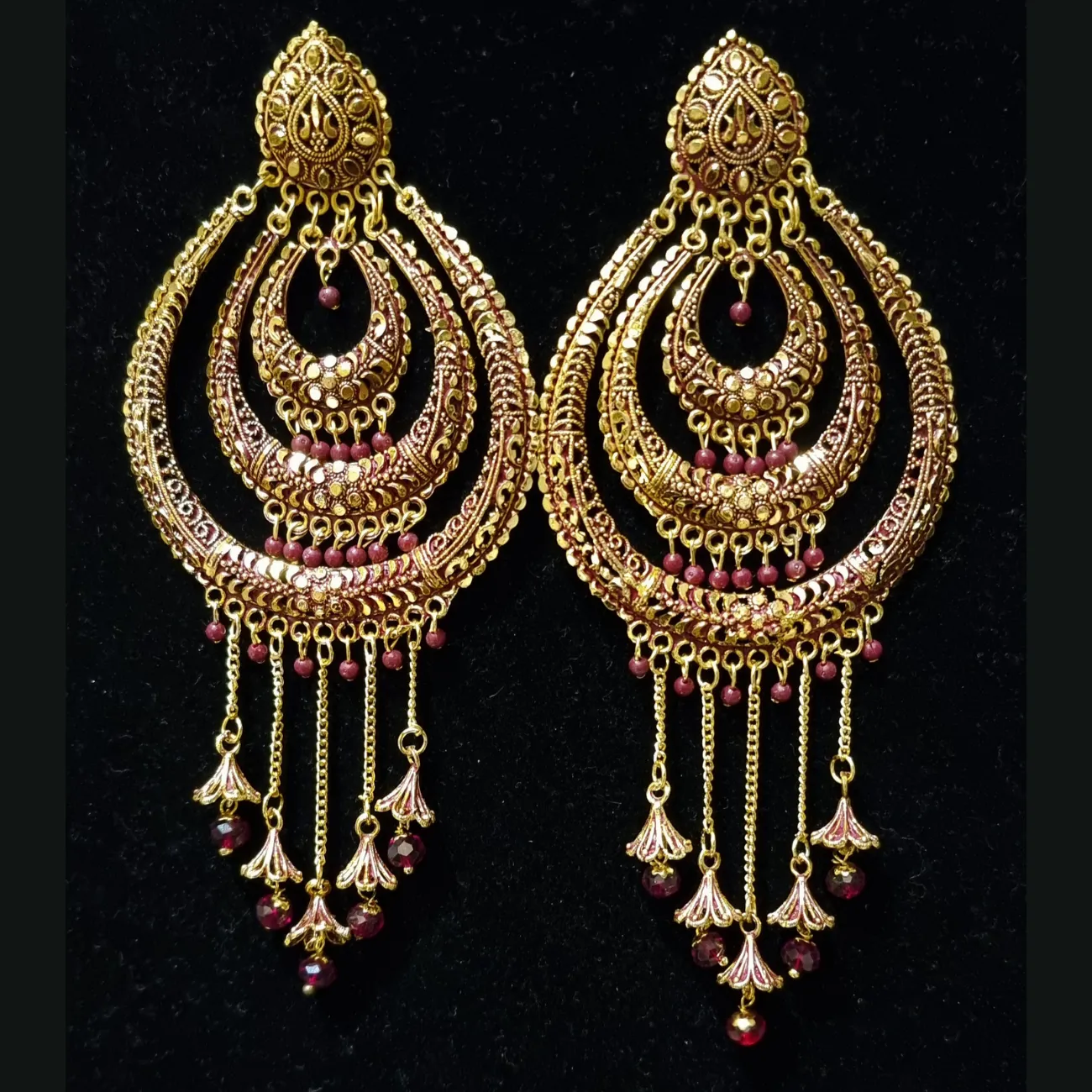 Long jhumka style earrings with tassels.